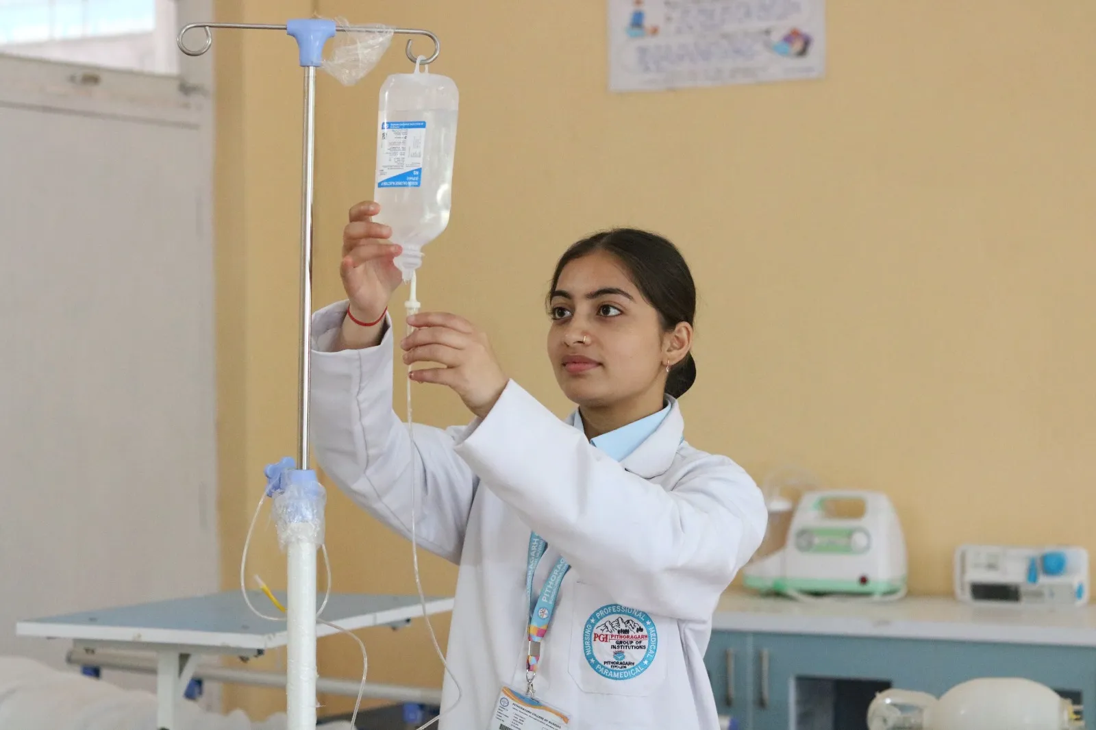 A nursing student setting up an intravenous drip at PGI Pithoragarh